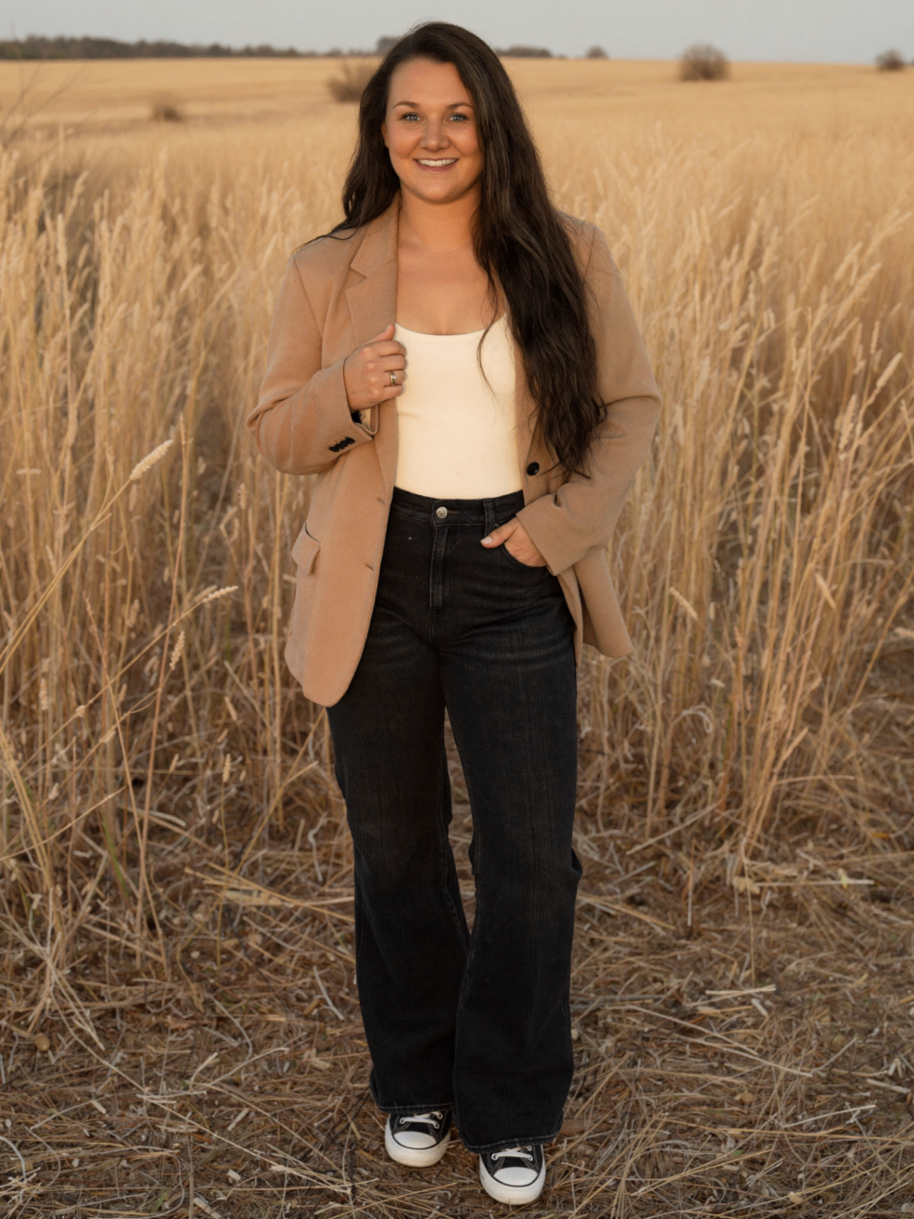 Confident woman in cream and camel